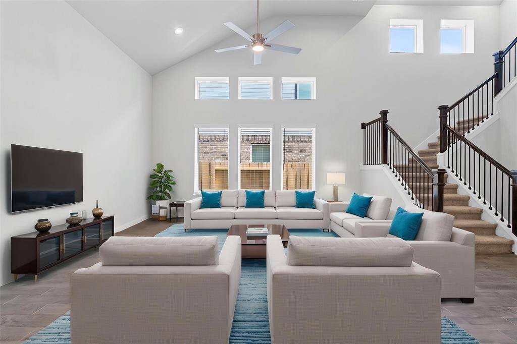 Gather the family and guests together in your lovely family room! Featuring high ceilings, recessed lighting, ceiling fan, custom paint, gorgeous wood look floors, and large windows with blinds that provide plenty of natural lighting throughout the day.