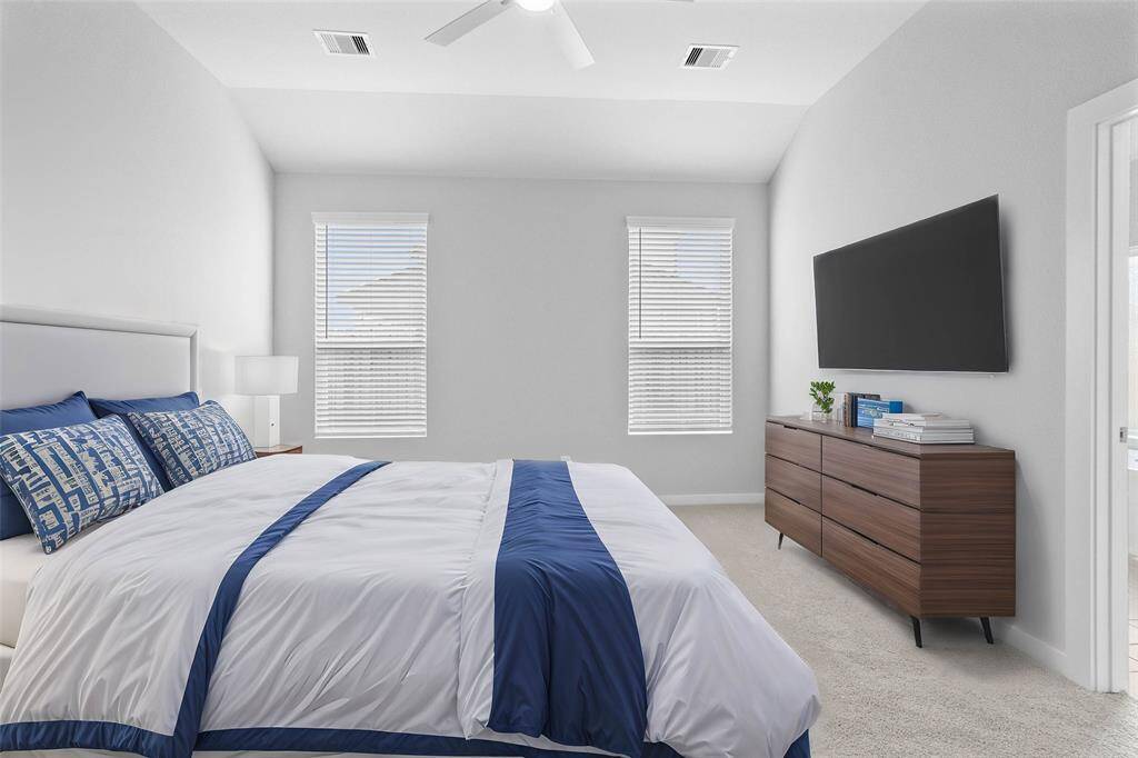 Come and unwind after a long day in this magnificent primary suite! This spacious room features plush carpet, warm paint, high ceilings with ceiling fan, and large windows with privacy blinds.