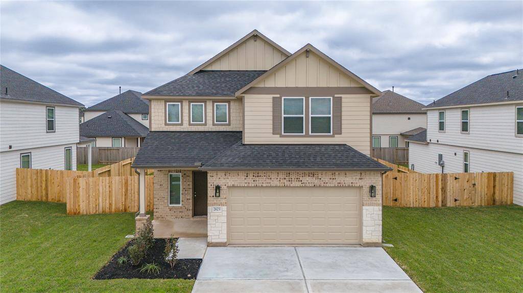 Aerial shot of the home showcasing the ample side yard space and lush landscaping.