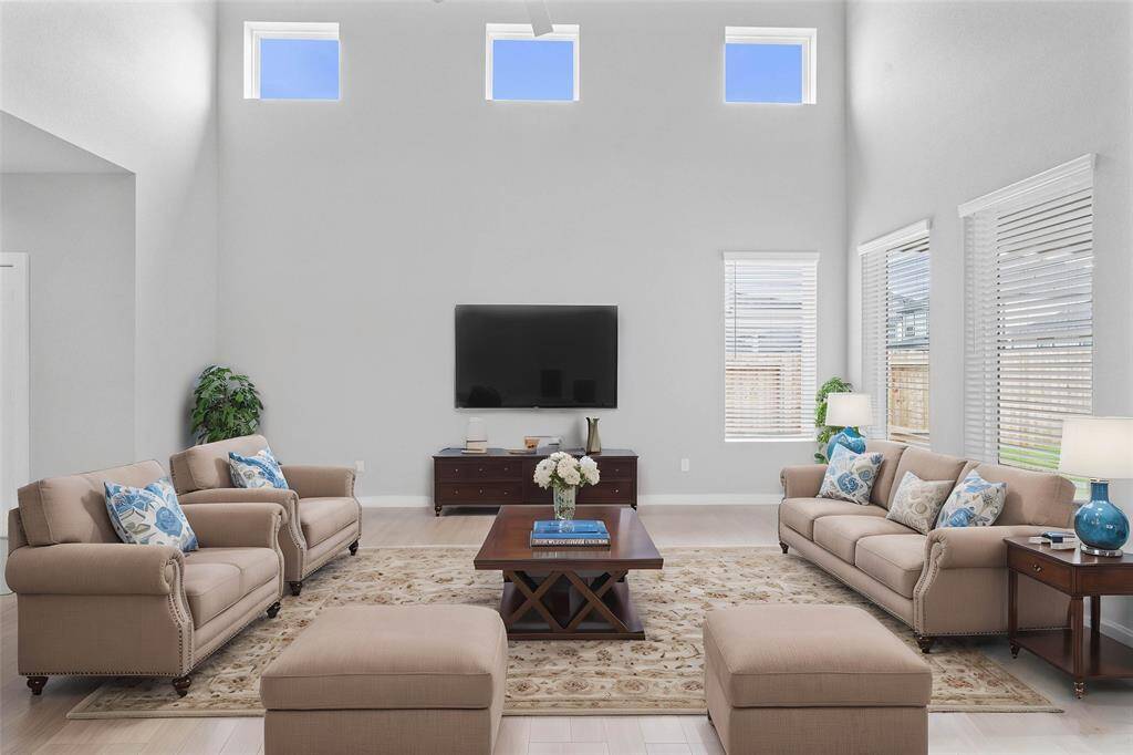 Gather the family and guests together in your lovely family room! Featuring high ceilings with ceiling fan, custom paint, gorgeous wood look floors and large windows that provide plenty of natural lighting throughout the day.