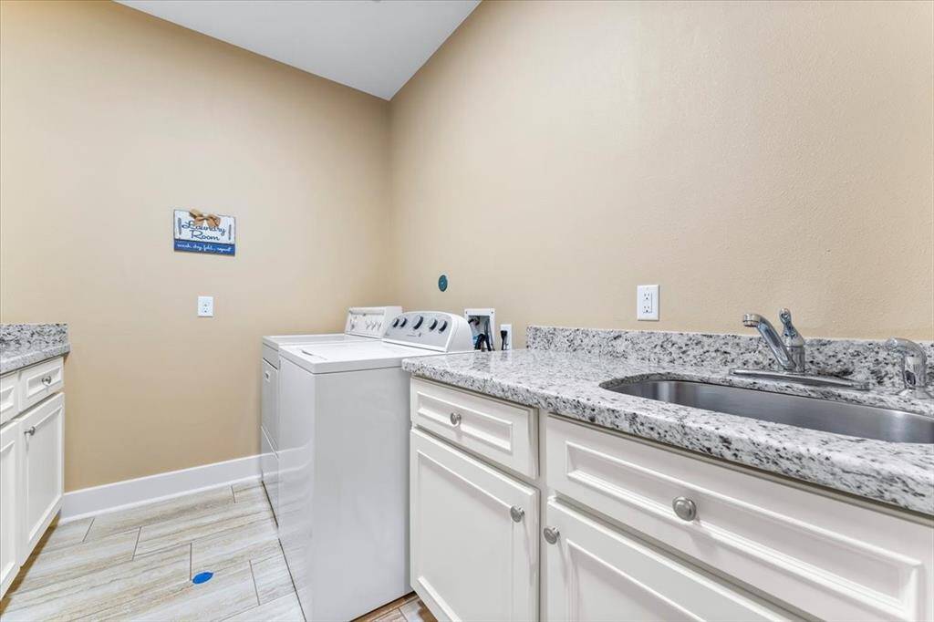 The utility room features a wash sink and additional cabinets, providing extra storage and functionality.