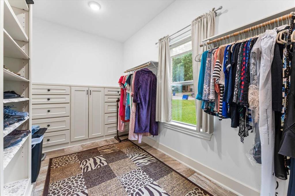 Huge walk-in closet with custom built-ins.