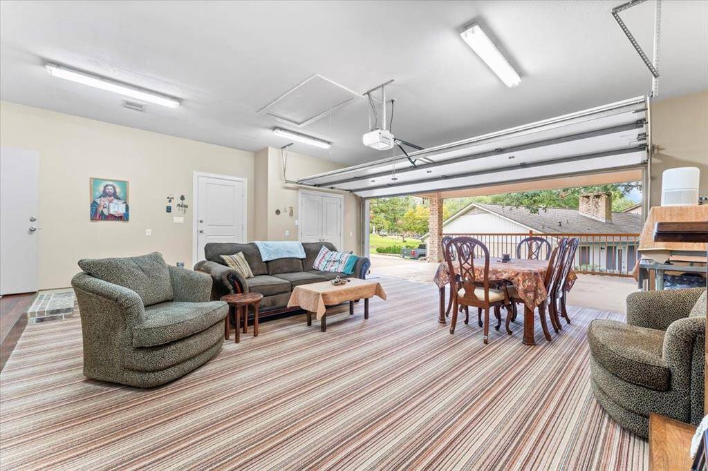 Garage currently being used has as sitting area. Garage has carpet but is not glued down, can easily be removed. Concrete in garage looks brand-new.