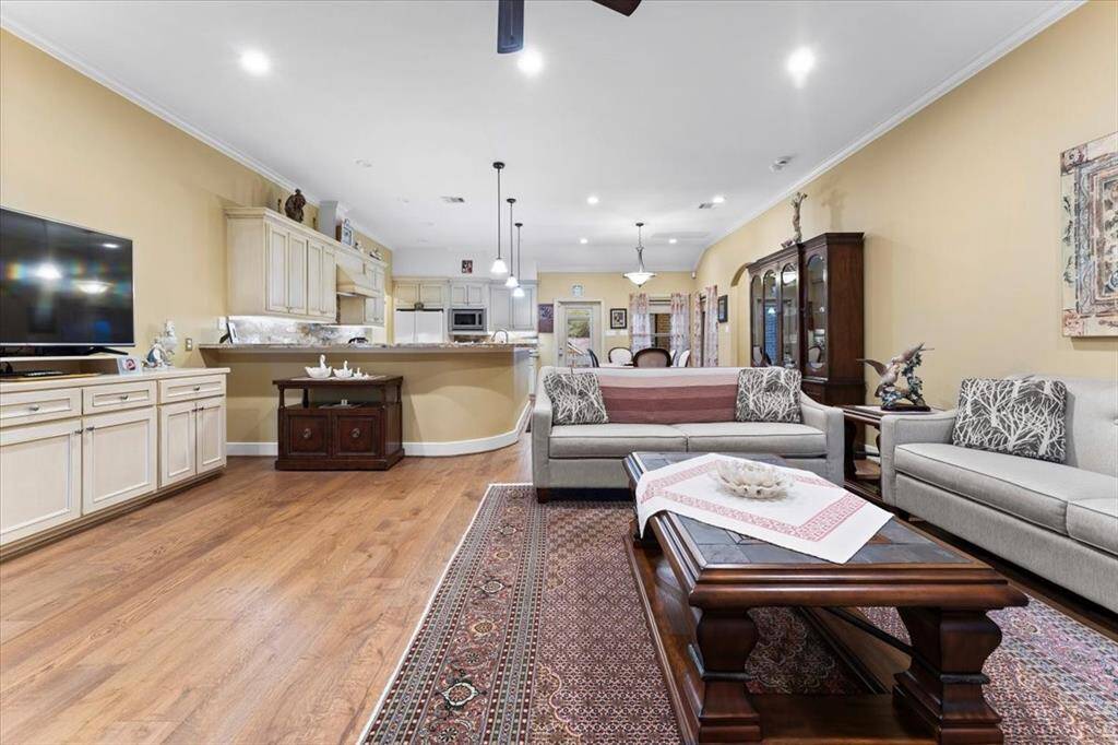 As you enter, you're immediately welcomed by an open concept family room, a built-in for your entertainment needs and an abundance of natural light.