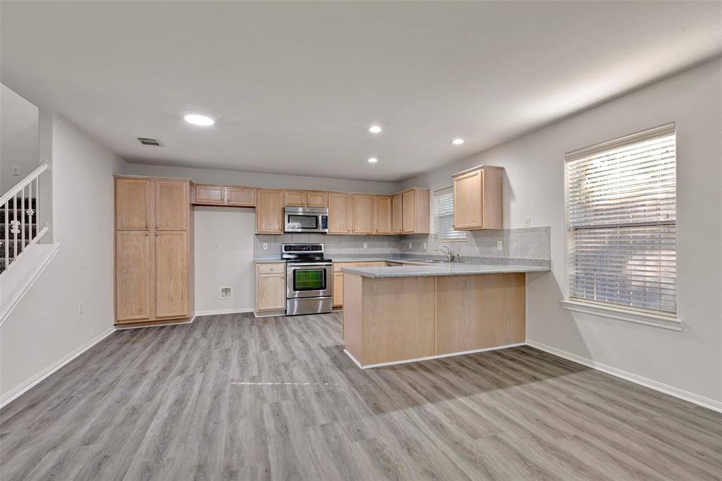 The kitchen has a lot of cabinets.