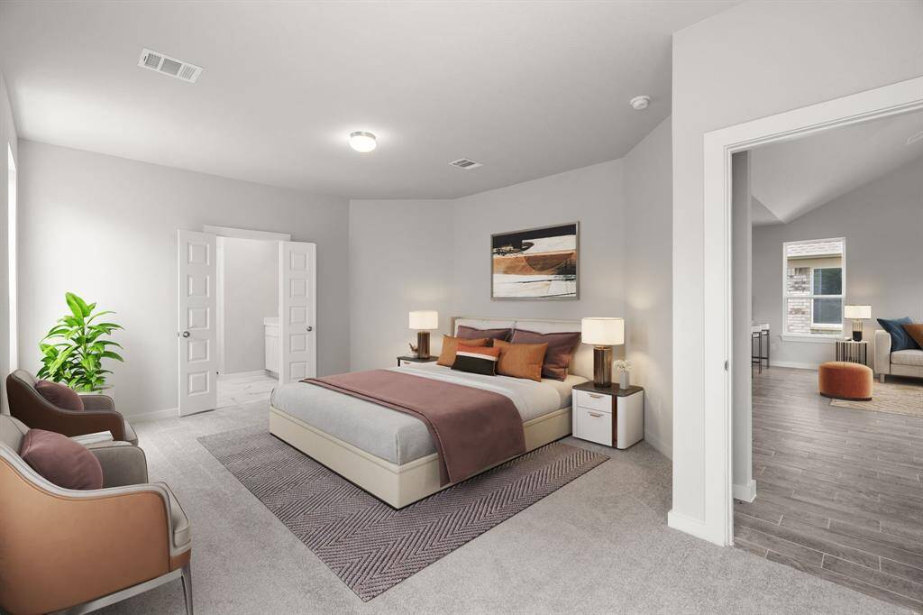 Escape and relax in the exquisite primary suite, a haven to unwind after a long day. The spacious room, located on first floor, boasts plush carpeting, soothing paint tones, high ceilings, and expansive windows adorned with privacy blinds. Sample photo of completed home with similar floor plan. As-built interior colors and selections may vary.