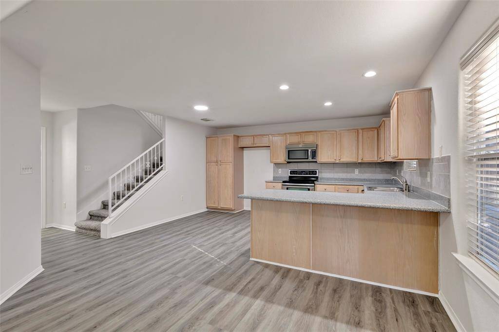 There is room in the kitchen for a cafe style table.