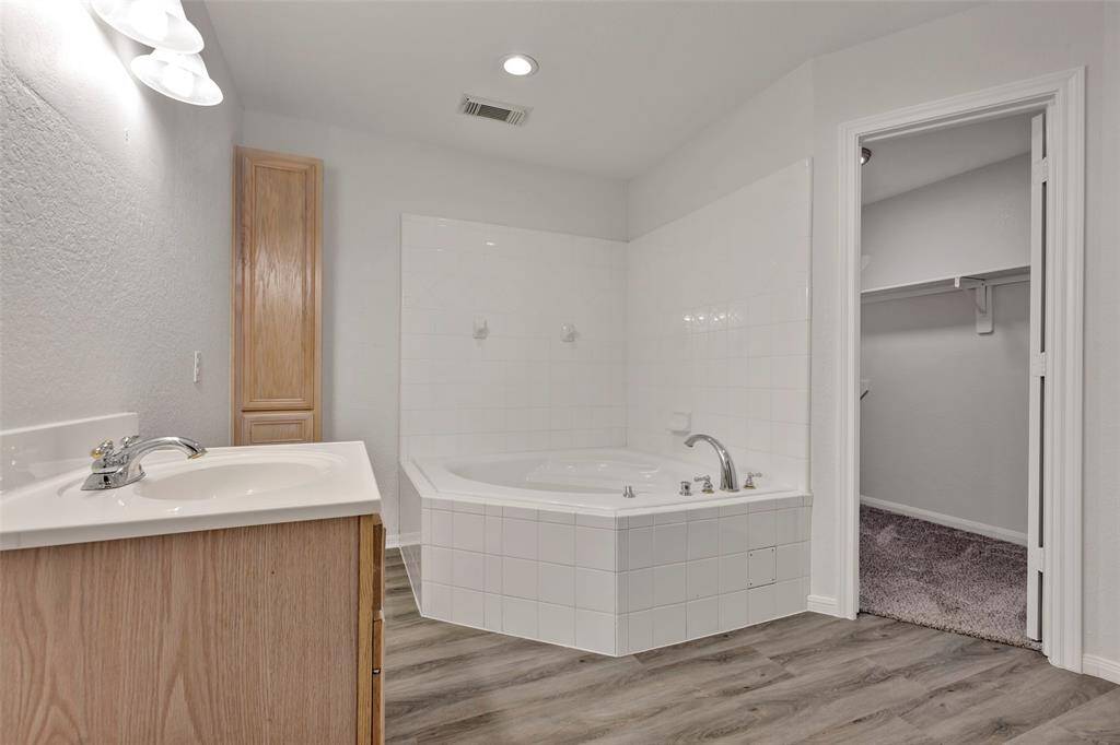 The downstairs bathroom has a large soaking tub and closet.