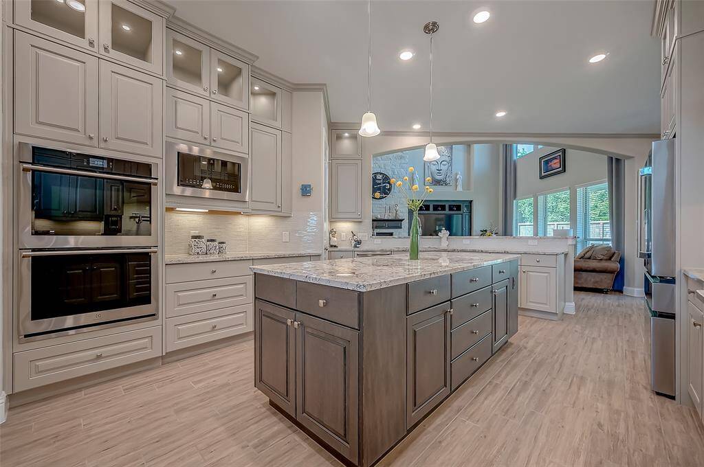 This over sized island has ample space for storage.  The cabinets are 42" J-Kraft frameless cabinets with designer hardware and under cabinet lighting. The cabinets above have lighting to showcase your prize possessions.