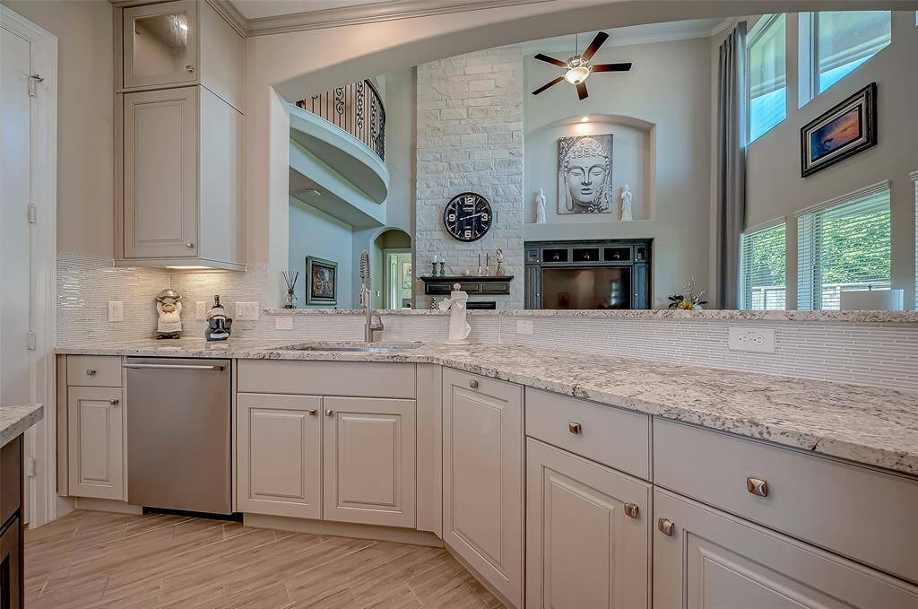 This thoughtfully laid-out kitchen features an open-concept design that effortlessly connects with the adjacent family room, allowing you to engage with your guests while preparing meals. Quiet dishwasher by ProClean. Beautiful granite countertops and elegant backsplash.