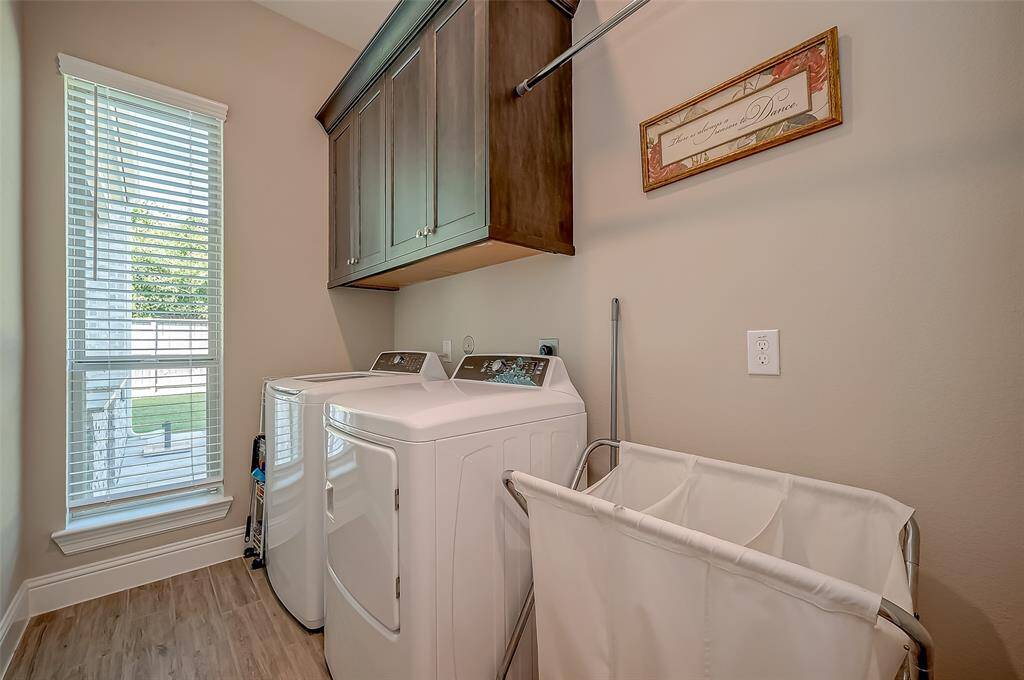 This laundry room is light and bright with cabinets for storage. Electric & gas connections. There is also room for a stand alone freezer.