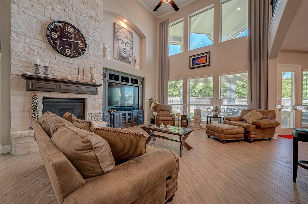 A centerpiece of the room, this gorgeous cast stone fireplace adds a touch of charm and warmth, creating a focal point that enhances the room’s cozy ambiance.