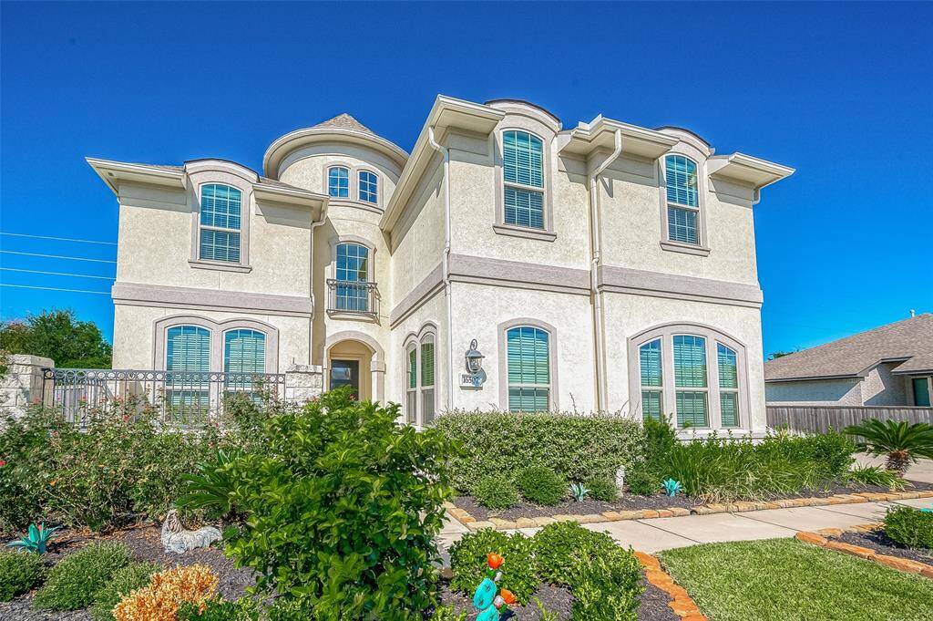 Gorgeous curb appeal with lush landscaping.