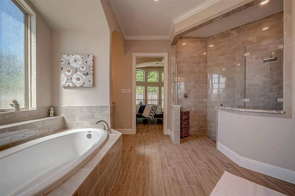 The centerpiece of the bath is an elegant oval garden tub, perfectly positioned for a soothing soak.