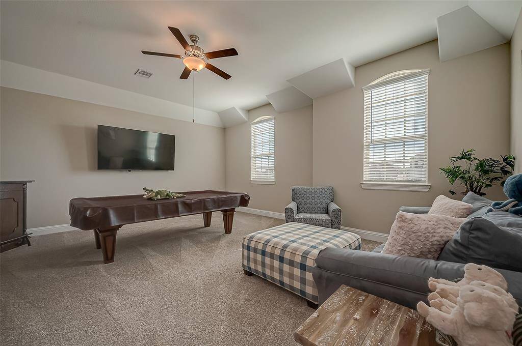 The game room is thoughtfully laid out to accommodate a range of activities, featuring dedicated zones for different types of games.