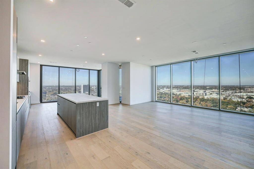 Floor-to-ceiling windows frame the urban panorama. Natural light illuminates the elegant space. Immerse yourself in the vibrant energy of the city, while relishing the comfort and luxury of this captivating living room retreat.