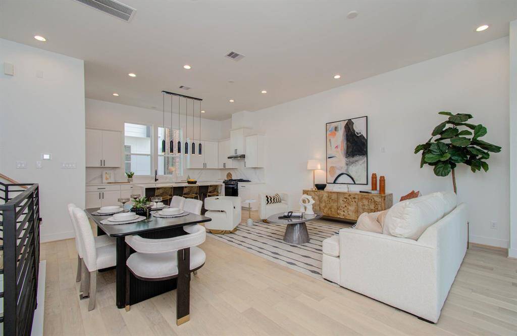 Large open concept living space features European white oak floors and 11 ft ceilings
