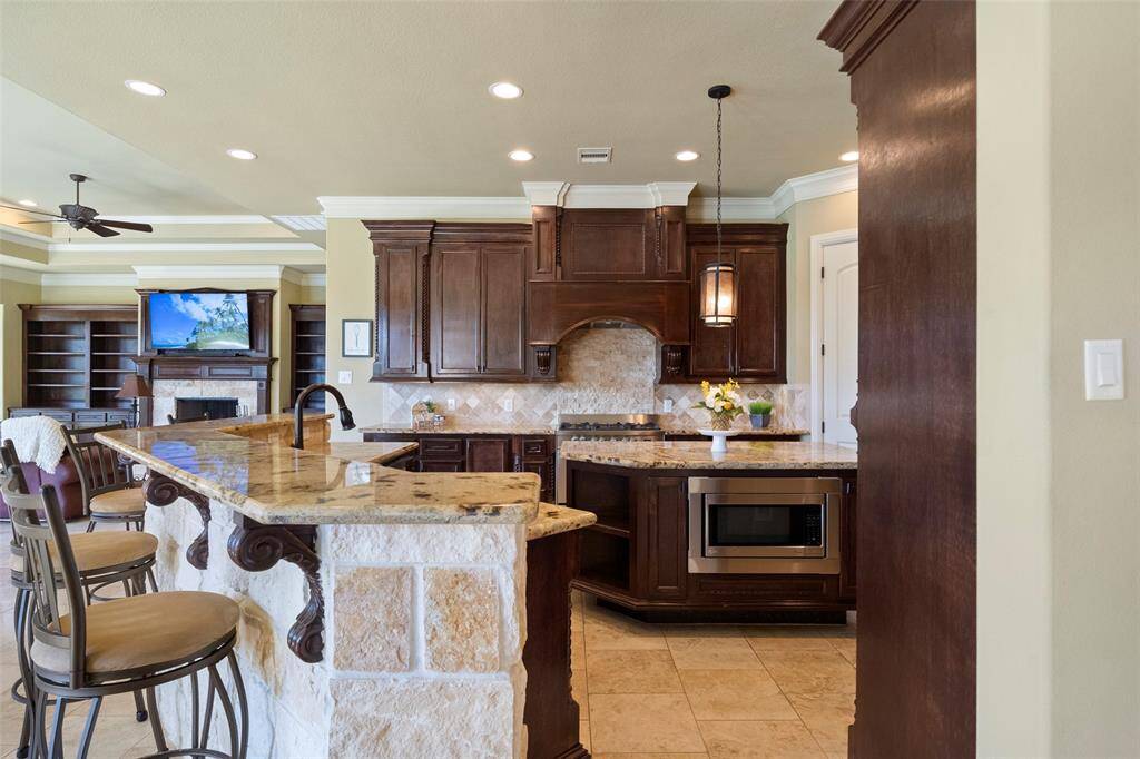 Enjoy seamless entertainment in the gourmet open kitchen, perfect for cooking while indulging in your favorite shows.