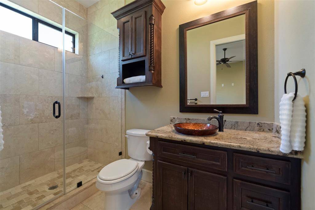 Ensuite bathroom with elegant finishes, including a spacious walk-in shower and a stylish vessel sink.