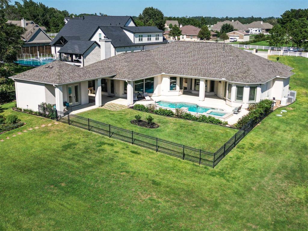 Discover the elegance of single-story living with this expansive home, boasting a pristine lawn, private in-ground pool, and inviting covered patio. The property's contemporary style is complemented by abundant space for outdoor entertainment, all secured by a stylish metal fence ideal for families with children and pets.