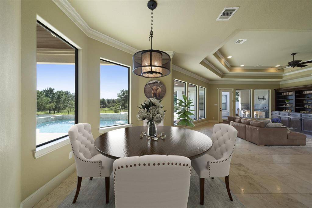 Savor your morning brew at the breakfast nook with serene lake views in your secluded backyard oasis. Virtually Staged.