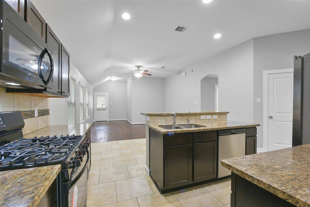 The spacious layout seamlessly connects the living, dining, and kitchen areas, making it an entertainer’s dream.