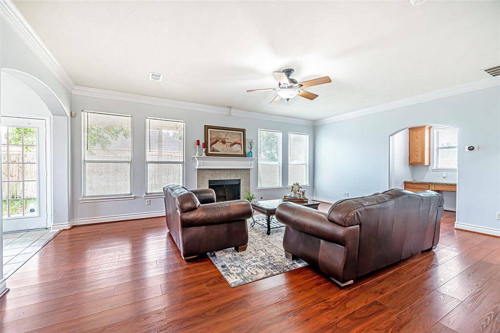 The living room offers an expansive space centered around the gas fireplace.