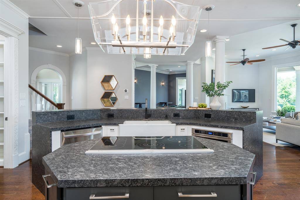 Granite breakfast bar offers additional seating and convenient return staircase.