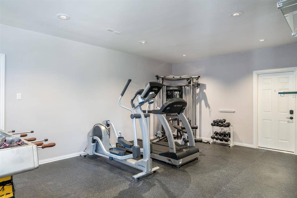The second oversized garage has been converted to a large workout room with adjacent storage.