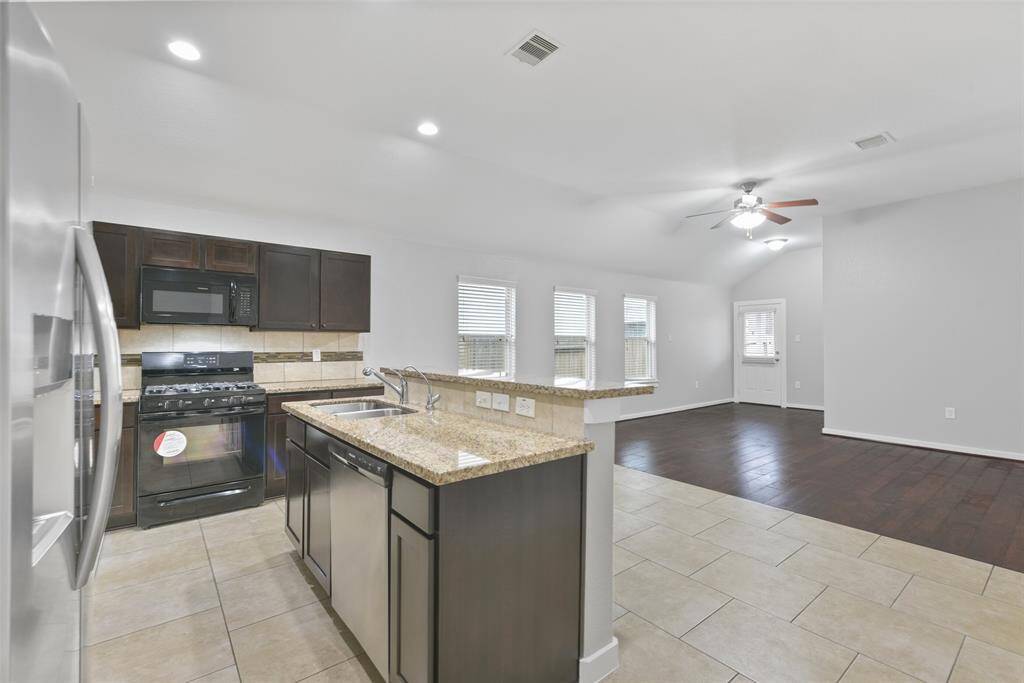 Step into the open-concept living space, perfect for hosting family gatherings or cozy get-togethers with friends.