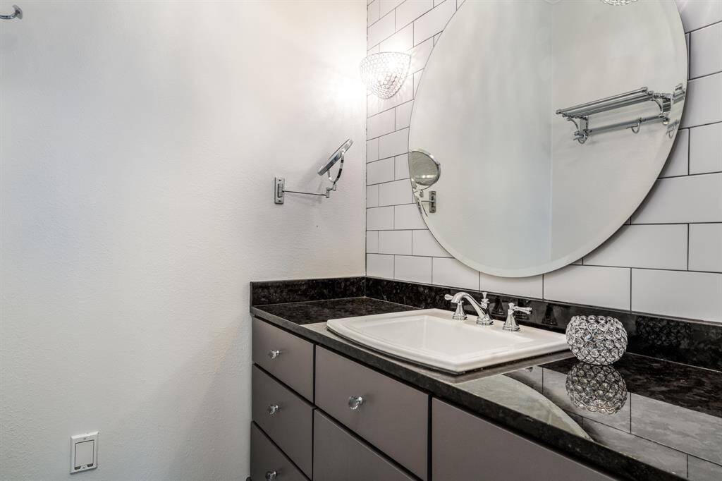 Another updated bath with subway tile, including the shower surround, and granite counter.