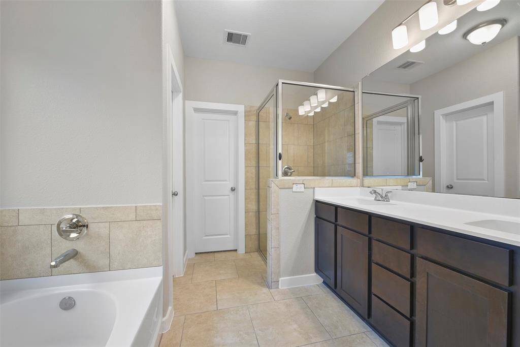 Relax after a long day at work in this primary bathroom