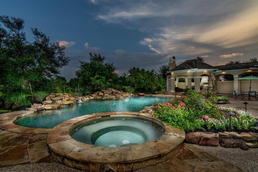 Beautiful landscape lighting around the pool area.