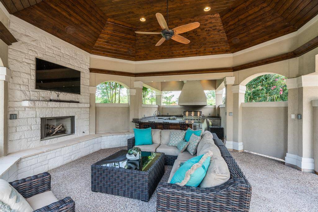 Covered party patio offers a gas fireplace and seating area.
