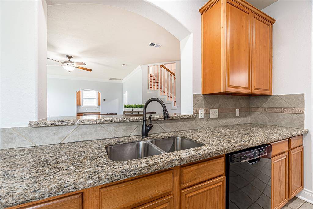 The kitchen offers granite counter tops, pantry and opens to the living area.