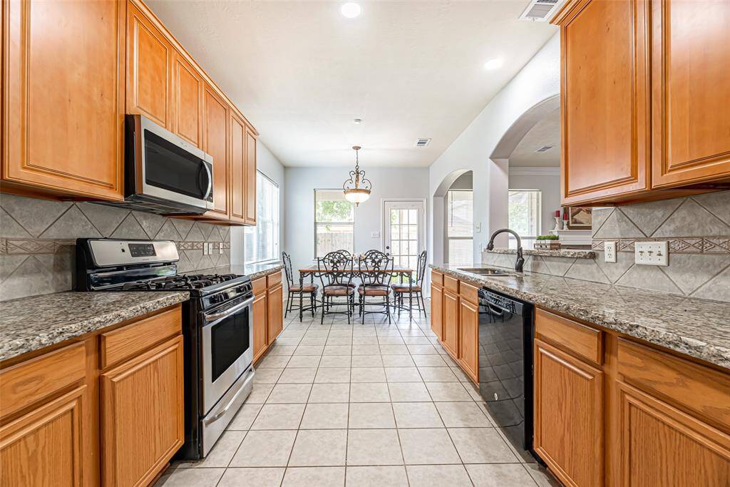 New LED recessed lighting and all wood upper cabinetry are among the many upgrades within the kitchen.