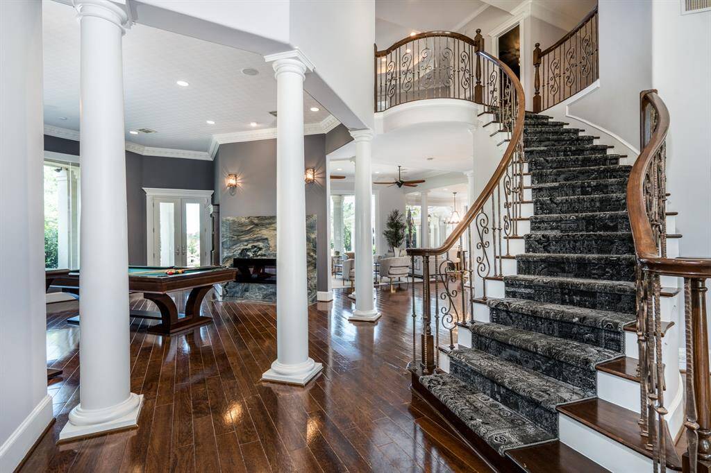 Opposite view of the entry with the curved staircase and open entertainer's floor plan.