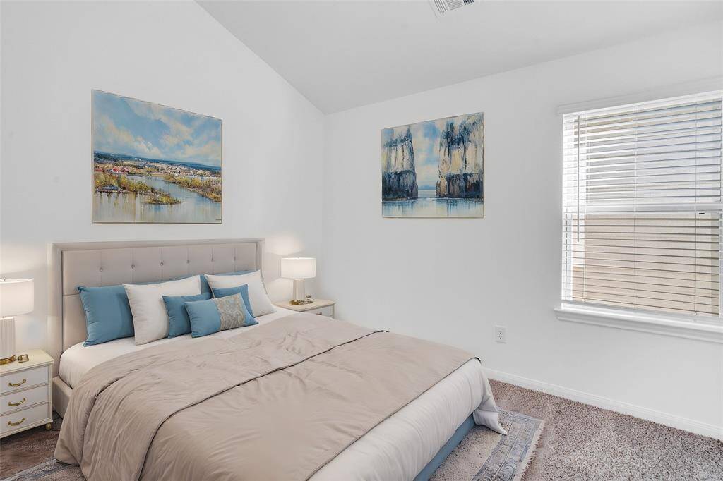 Secondary bedroom features plush carpet, neutral paint, high ceilings, and a large window with privacy blinds. *virtually staged*