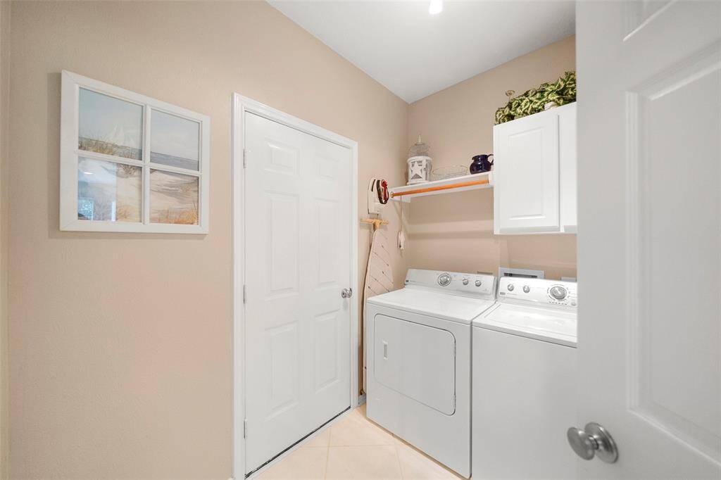 Laundry room features cabinets & access to garage.