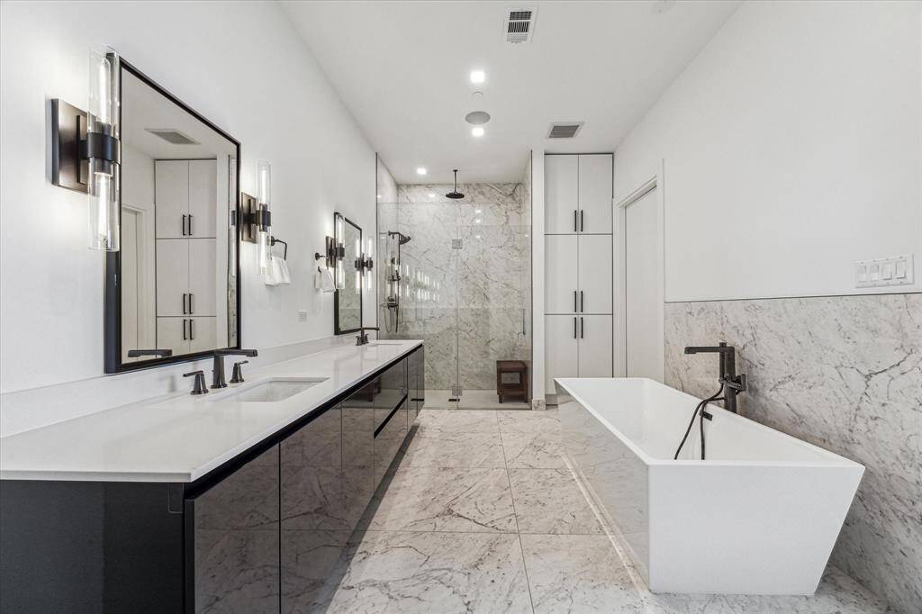 Primary bath retreat offers a large edgeless shower, soaking tub, double vanity and private water closet.