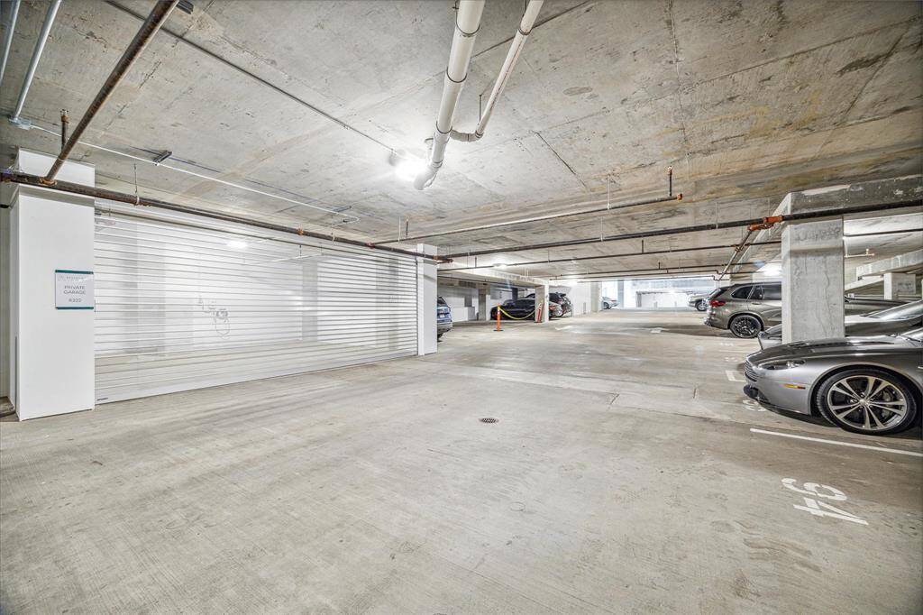Private two car interior garage with EV charging station.