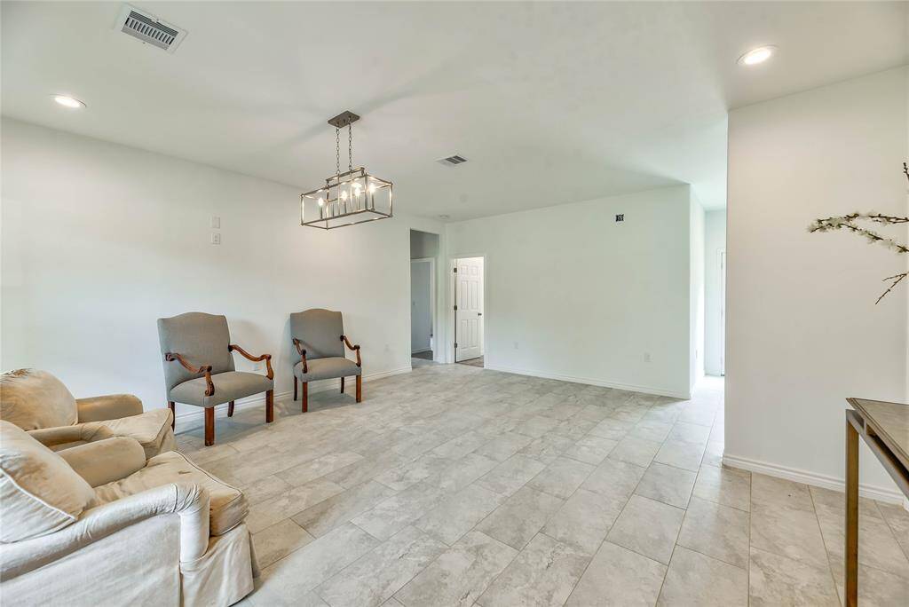 LIVING AREA ,TILE FLOORS AND LOTS OF WINDOWS
