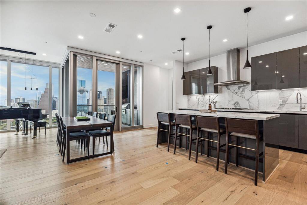 Sleek island kitchen with Pedini cabinetry, gas cooking and Thermador appliances. 10 ft. ceilings, wide plank hardwoods, porcelain counters and recessed lighting.