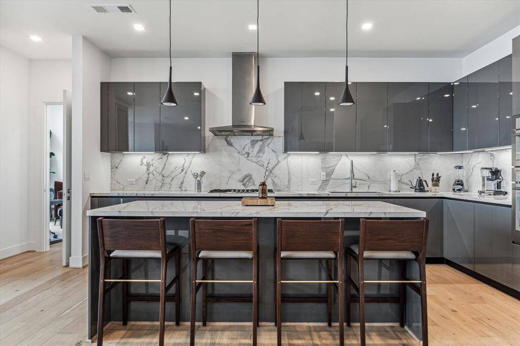 Island Kitchen  features Thermador appliances, gas cook top, porcelain counter tops and back splashes.