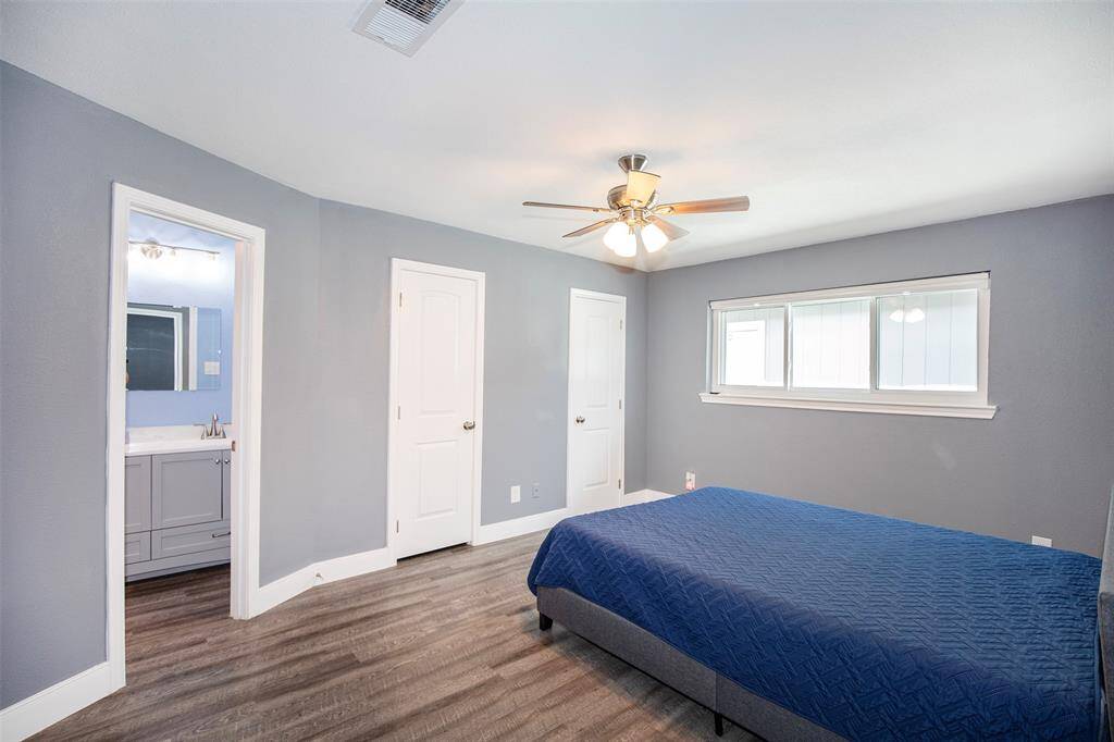 The primary suite is a serene retreat that features beautiful flooring that adds warmth and sophistication.