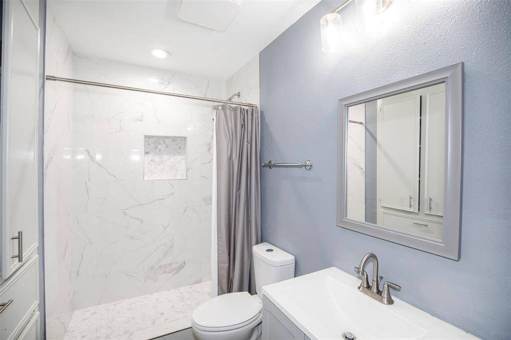 The guest bathroom is a lovely and functional space that is designed to provide comfort and convenience.