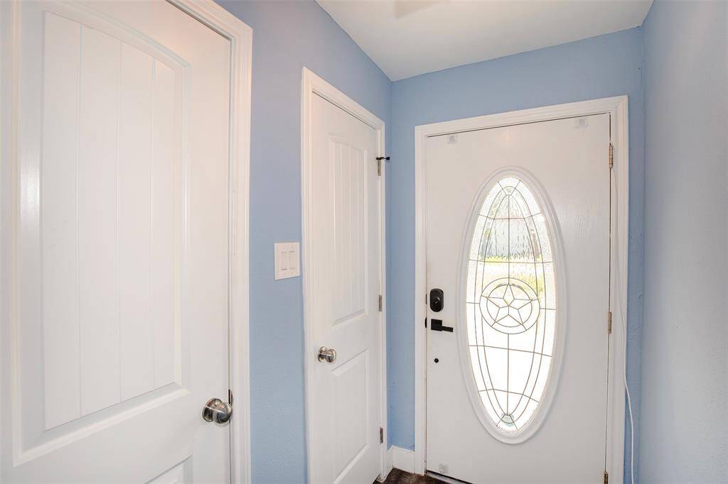 The front door has a marvelous design with leaded glass. You will also find two coat closets in the entryway.