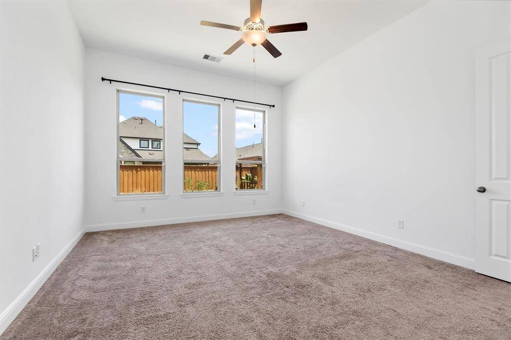 Primary bedroom with ceiling fan