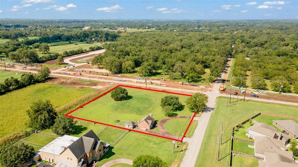 Approx. 1.9 acres with a small home and available space for your Dream home or a commercial development.