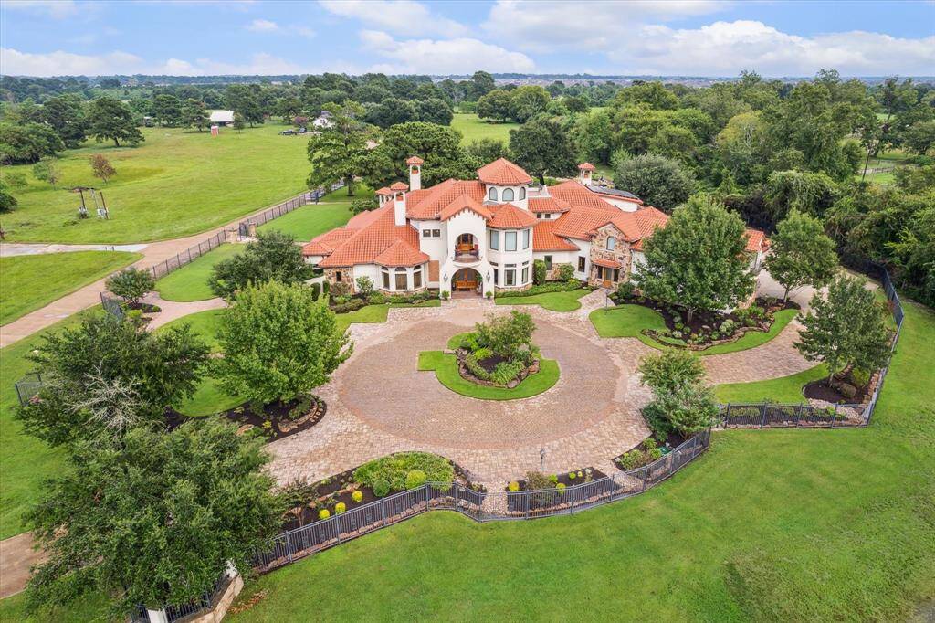 This sprawling Mediterranean estate is located on almost 6 unrestricted acres in suburban Tomball and features over 11,000 square feet of interior living space comprised of natural materials with rich moments of color and texture. Meticulous planning and attention to detail have outfitted this home with state of the art technology and modern conveniences while remaining consistent with the old-world aesthetic of the Mediterranean design.